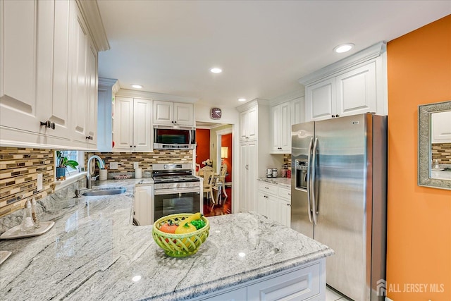 10 Dellview Dr, Edison, NJ 08820 - kitchen with stainless steel appliances, decorative backsplash, white cabinets, light stone countertops, and recessed lighting