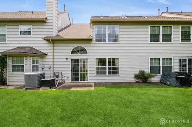 349 Lunar Rd, Piscataway, NJ 08854 - rear view of house featuring a yard, a shingled roof, a chimney, and a patio