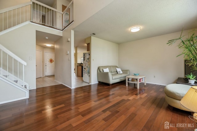 349 Lunar Rd, Piscataway, NJ 08854 - living area with wood finished floors, stairway, and a textured ceiling