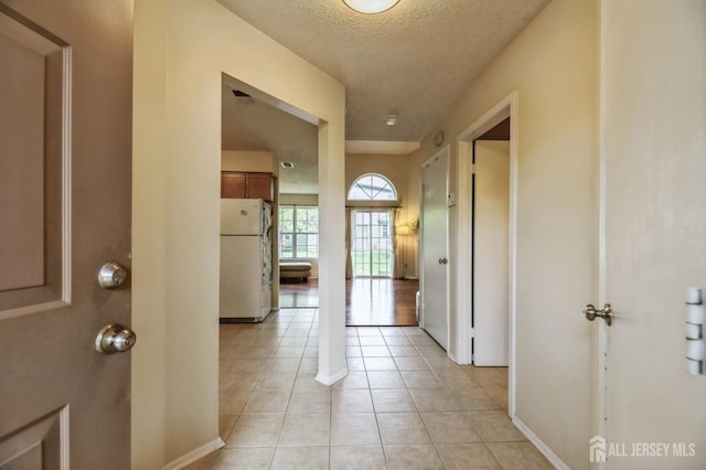 349 Lunar Rd, Piscataway, NJ 08854 - hallway featuring light tile patterned flooring and a textured ceiling