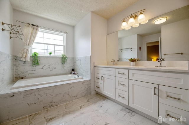 349 Lunar Rd, Piscataway, NJ 08854 - full bathroom featuring double vanity, marble finish flooring, a garden tub, and a textured ceiling