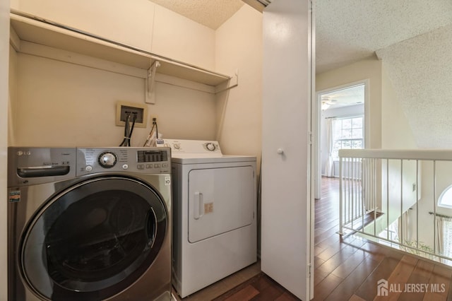 349 Lunar Rd, Piscataway, NJ 08854 - laundry area with washing machine and clothes dryer, a textured ceiling, and dark wood-style flooring