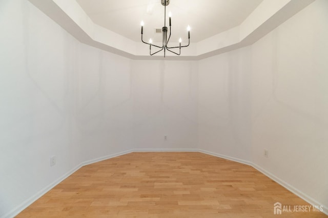1109 Cedar Village Blvd, East Brunswick, NJ 08816 - spare room with a chandelier, light wood finished floors, and baseboards