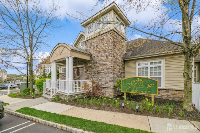 1109 Cedar Village Blvd, East Brunswick, NJ 08816 - view of front of house featuring stone siding, uncovered parking, and french doors