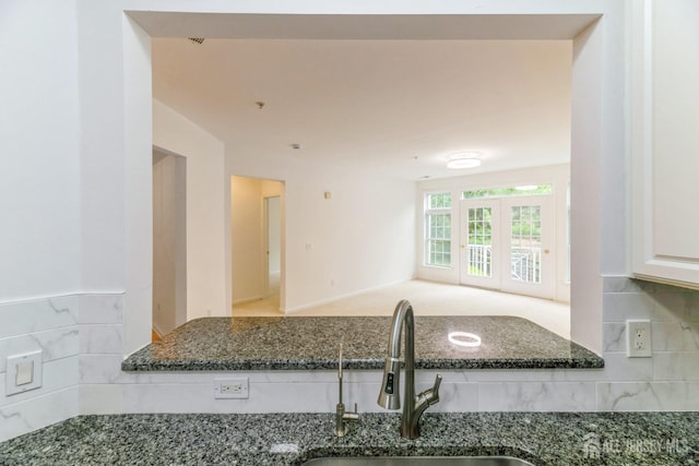 1109 Cedar Village Blvd, East Brunswick, NJ 08816 - kitchen featuring a sink, tasteful backsplash, dark stone countertops, and white cabinets