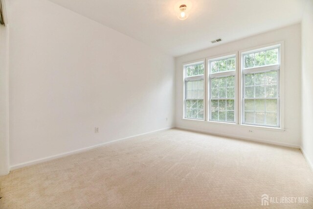 1109 Cedar Village Blvd, East Brunswick, NJ 08816 - spare room featuring light carpet and baseboards
