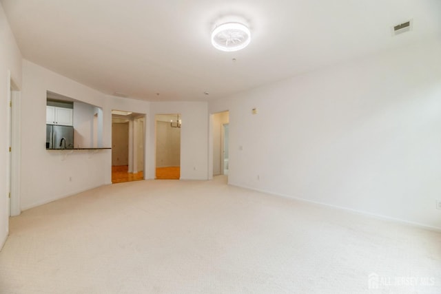 1109 Cedar Village Blvd, East Brunswick, NJ 08816 - unfurnished living room featuring light colored carpet