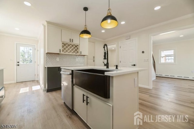 88 Roosevelt Ave, Old Bridge, NJ 08879 - kitchen with a sink, recessed lighting, healthy amount of natural light, a baseboard radiator, and ornamental molding