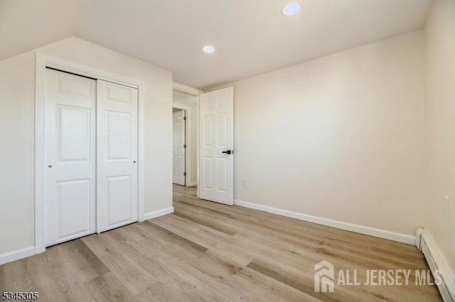 88 Roosevelt Ave, Old Bridge, NJ 08879 - unfurnished bedroom featuring baseboard heating, light wood-style floors, baseboards, recessed lighting, and a closet