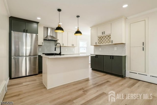 88 Roosevelt Ave, Old Bridge, NJ 08879 - kitchen featuring freestanding refrigerator, wall chimney range hood, light countertops, light wood-type flooring, and recessed lighting
