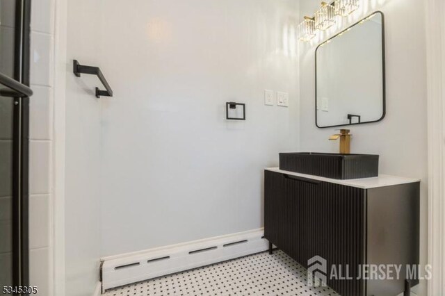 88 Roosevelt Ave, Old Bridge, NJ 08879 - bathroom featuring baseboard heating, vanity, tile patterned floors, and baseboards