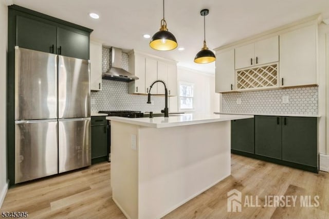 88 Roosevelt Ave, Old Bridge, NJ 08879 - kitchen with freestanding refrigerator, wall chimney exhaust hood, light countertops, backsplash, and light wood finished floors