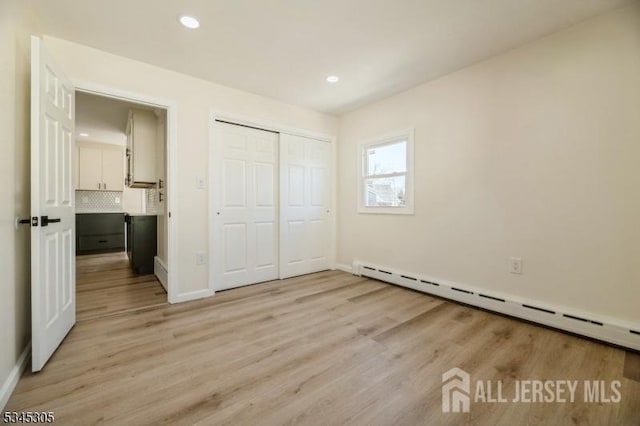 88 Roosevelt Ave, Old Bridge, NJ 08879 - unfurnished bedroom featuring baseboard heating, light wood-style floors, recessed lighting, baseboards, and a closet