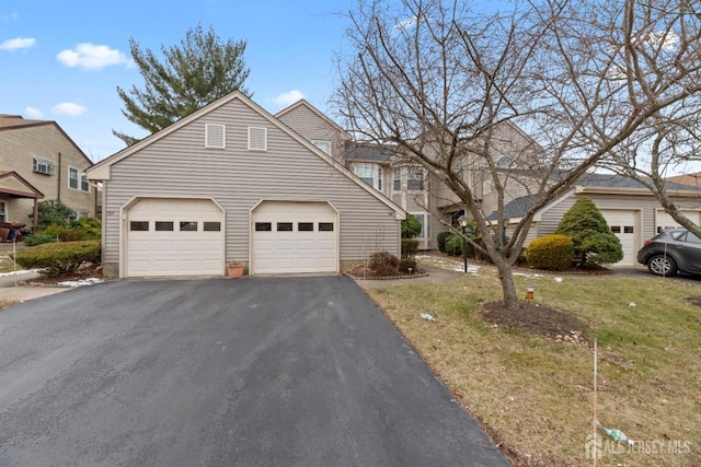 view of front property with a front yard and a garage