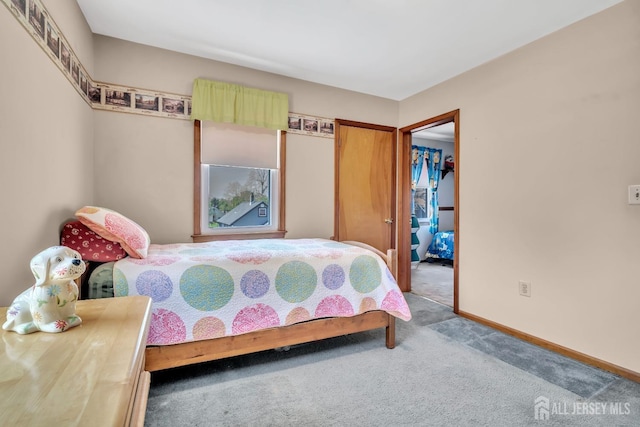 carpeted bedroom with baseboards and a closet