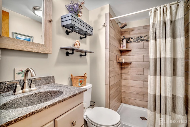 full bath with vanity, a stall shower, and toilet