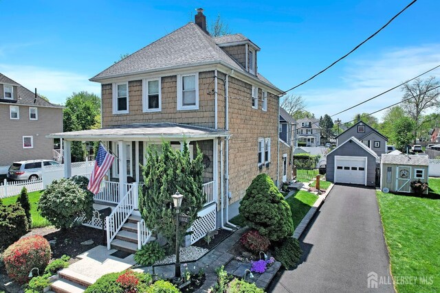 112 Adeline Ave, South Plainfield, NJ 07080 - view of front of home with an outbuilding, a garage, asphalt driveway, a shingled roof, and covered porch