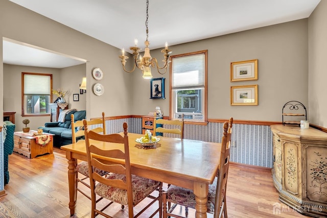 dining space with an inviting chandelier and light wood finished floors