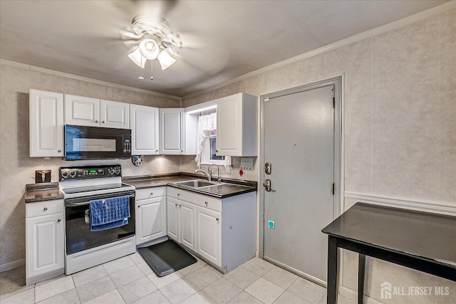 12 Church St, Sayreville, NJ 08872 - kitchen with electric range, black microwave, dark countertops, white cabinets, and light tile patterned flooring