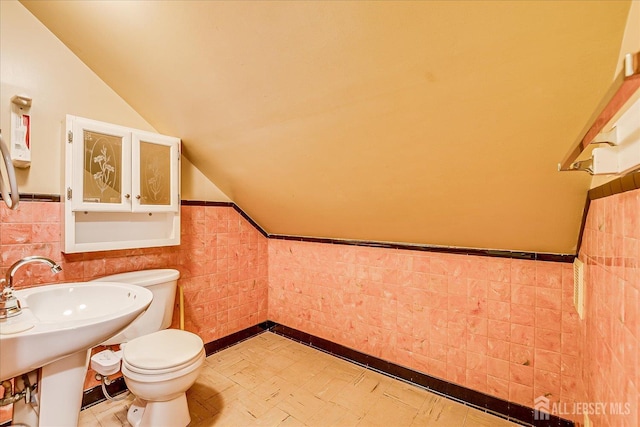 12 Church St, Sayreville, NJ 08872 - bathroom with lofted ceiling, wainscoting, tile patterned floors, and tile walls