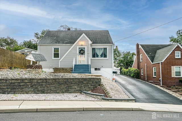 12 Church St, Sayreville, NJ 08872 - view of front of home with asphalt driveway and a shingled roof
