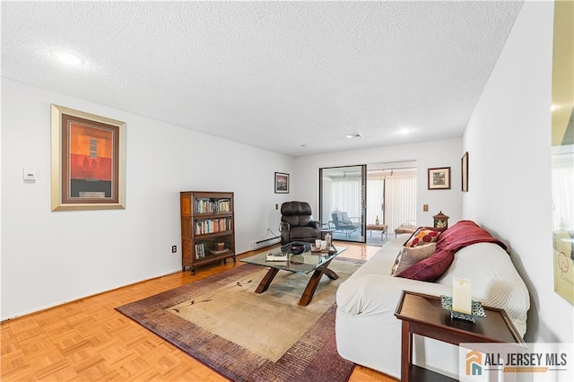 living area featuring a textured ceiling and a baseboard heating unit