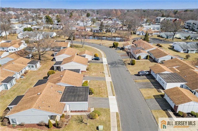 aerial view with a residential view and a water view