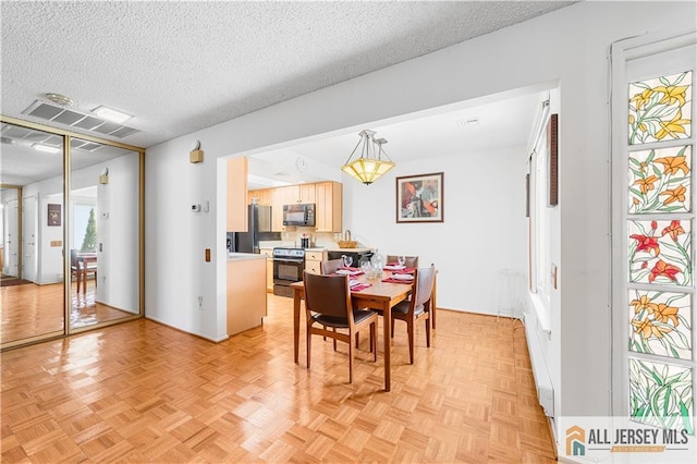 dining room with visible vents and a textured ceiling