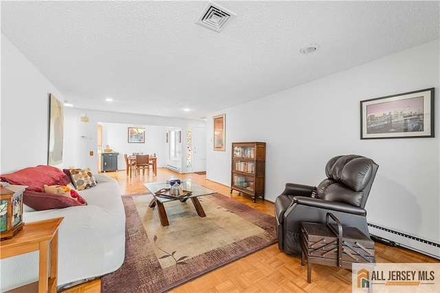 living room with a baseboard heating unit, recessed lighting, visible vents, and a textured ceiling