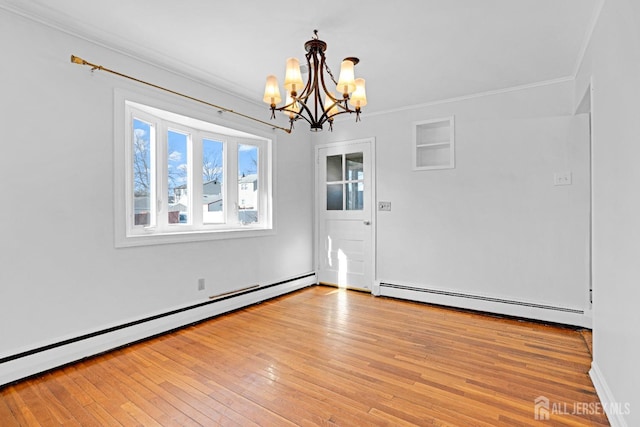 unfurnished dining area with a baseboard heating unit, ornamental molding, a notable chandelier, and light hardwood / wood-style floors