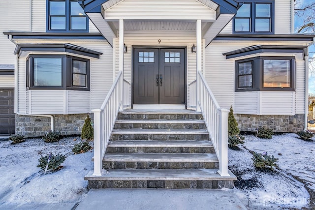 view of snow covered property entrance