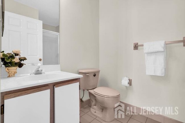 84 Prestwick Way, Edison, NJ 08820 - full bathroom featuring toilet, tile patterned flooring, vanity, a shower with shower door, and baseboards