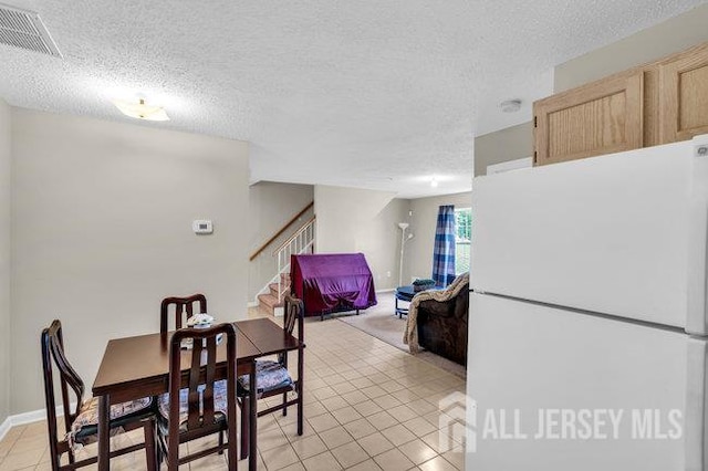 84 Prestwick Way, Edison, NJ 08820 - dining room featuring light tile patterned floors, stairway, and a textured ceiling