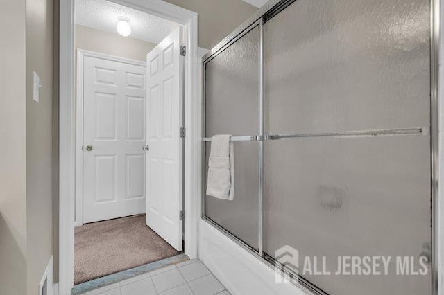 84 Prestwick Way, Edison, NJ 08820 - full bathroom featuring bath / shower combo with glass door, tile patterned floors, and a textured ceiling