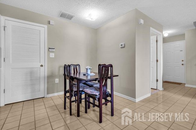 84 Prestwick Way, Edison, NJ 08820 - dining area with light tile patterned flooring, baseboards, and a textured ceiling