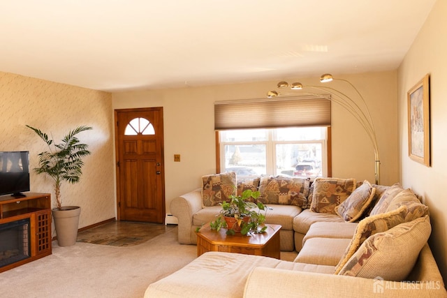 carpeted living area with a wealth of natural light, baseboards, and wallpapered walls