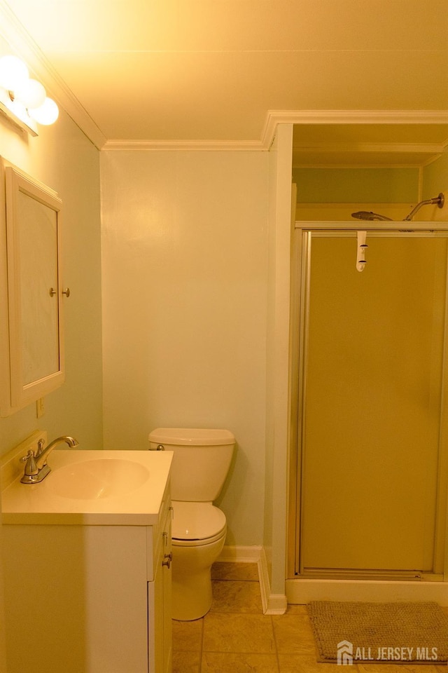 bathroom with a shower stall, tile patterned floors, vanity, and ornamental molding