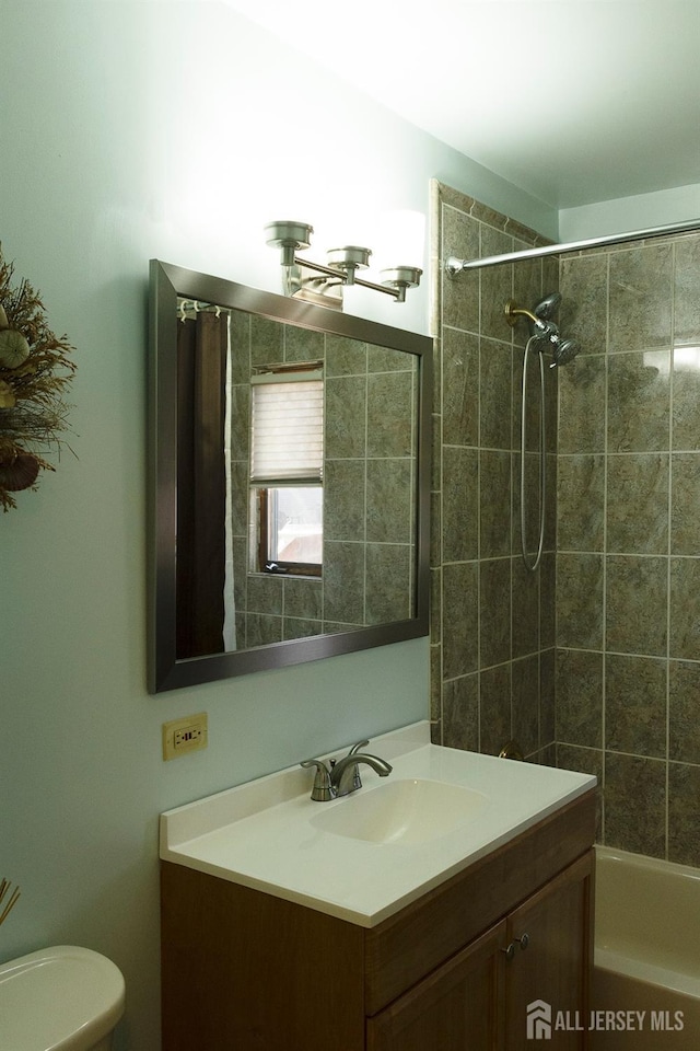 bathroom with toilet, vanity, and tub / shower combination