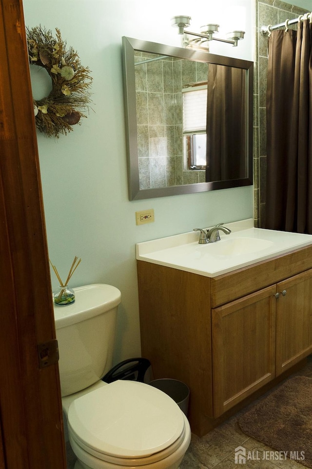 bathroom featuring toilet, tile patterned floors, vanity, and a shower with curtain