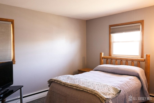 carpeted bedroom with baseboard heating