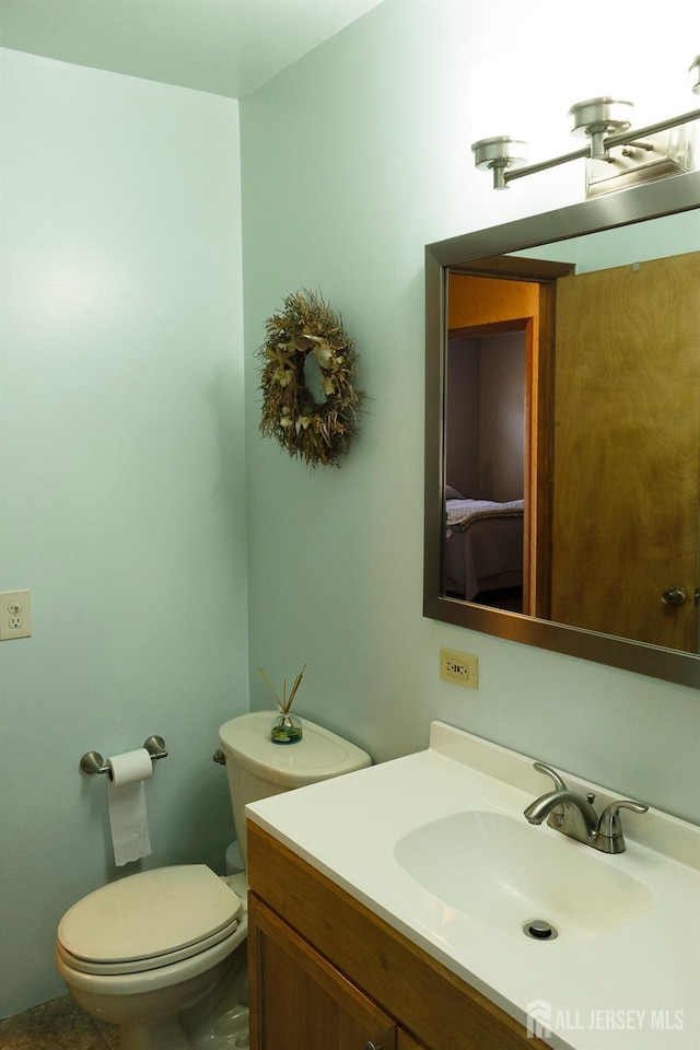half bathroom with toilet and vanity
