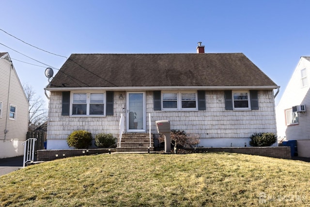 ranch-style home featuring entry steps, a front yard, a shingled roof, and a chimney