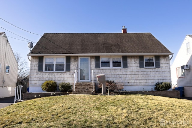 view of front of property with entry steps, a chimney, roof with shingles, and a front lawn