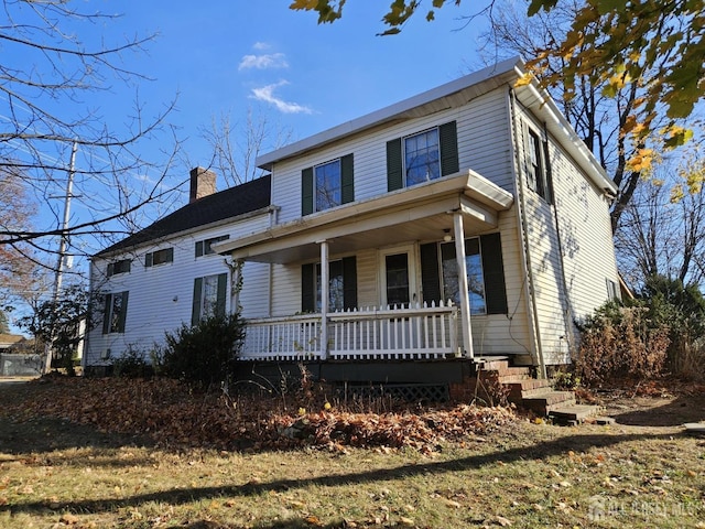 view of front of home featuring a porch and a chimney