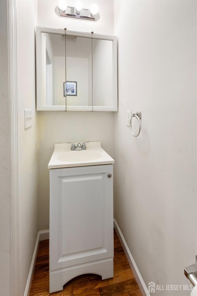 bathroom with vanity and wood-type flooring