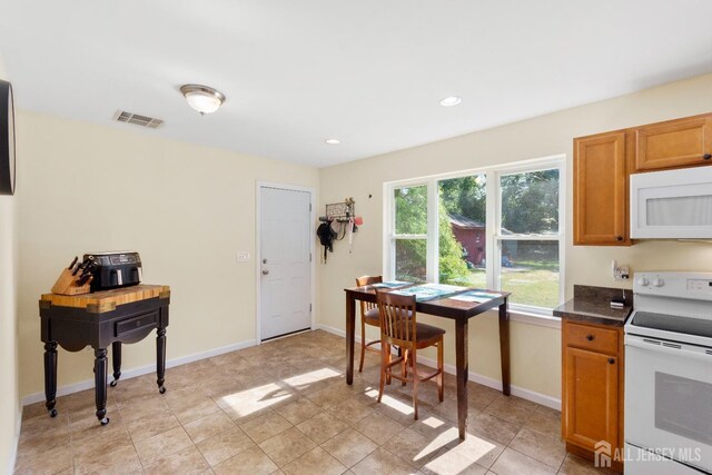 kitchen featuring white appliances and light tile patterned floors