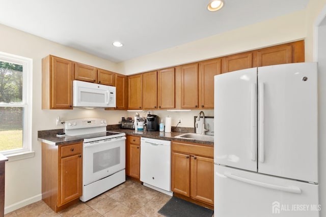 kitchen with white appliances, sink, and light tile patterned flooring