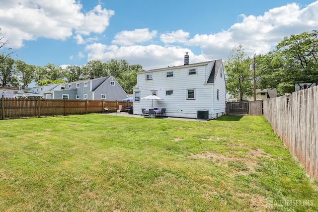 30 Clark Pl, Avenel, NJ 07001 - rear view of property featuring a patio area, a fenced backyard, and a chimney