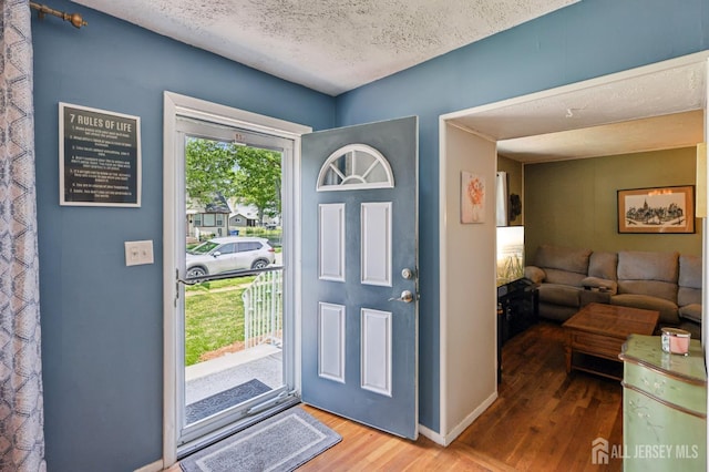 30 Clark Pl, Avenel, NJ 07001 - foyer entrance featuring wood finished floors and a textured ceiling