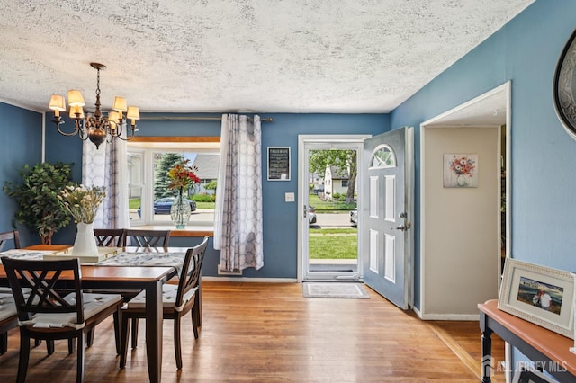 30 Clark Pl, Avenel, NJ 07001 - dining area featuring a chandelier, wood finished floors, and a textured ceiling